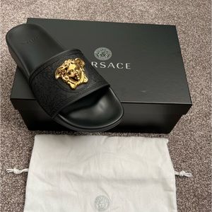 Black pool slides with gold emblem